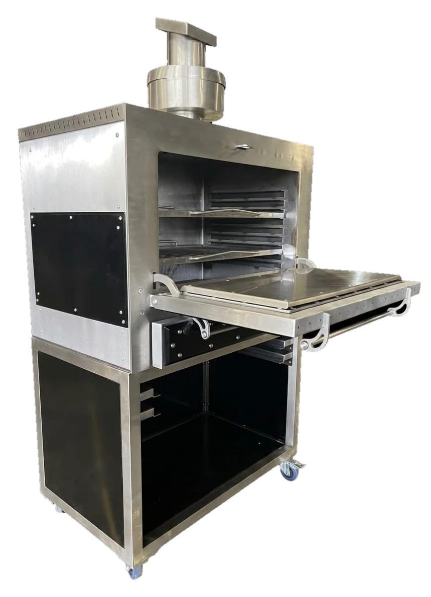 The Inferno 900 from the front left with its door folded down, showing two rod grids on runners in the stainless chamber, the stainless chimney on top and the open stand below on castors.