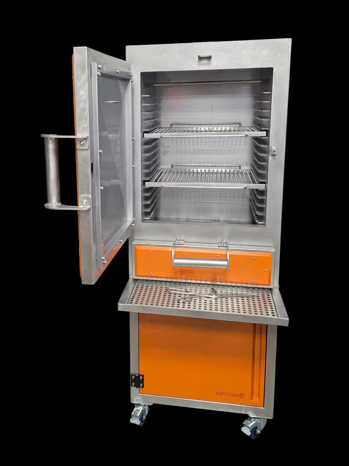 An Inferno Alto in an orange finish with its side-opening door swung open: the tall stainless chamber with two rod grids on runners, an orange ash drawer, a perforated shelf and an orange cabinet on castors.