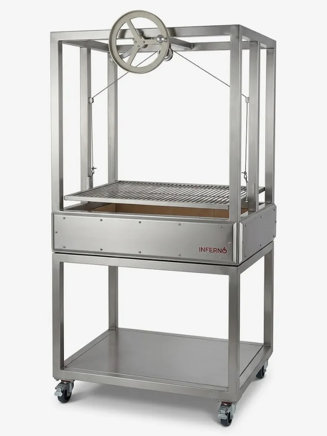 The Basque Parrilla crank-wheel live-fire grill on a stand.